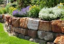 The Complete Guide to Boulder Retaining Walls and How They Can Save Your Landscape How Much Does A Boulder Retaining Wall Cost?
