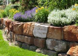 The Complete Guide to Boulder Retaining Walls and How They Can Save Your Landscape How Much Does A Boulder Retaining Wall Cost?