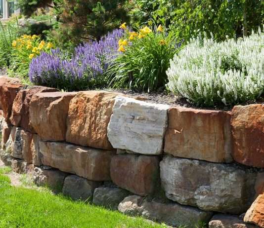 The Complete Guide to Boulder Retaining Walls and How They Can Save Your Landscape How Much Does A Boulder Retaining Wall Cost?